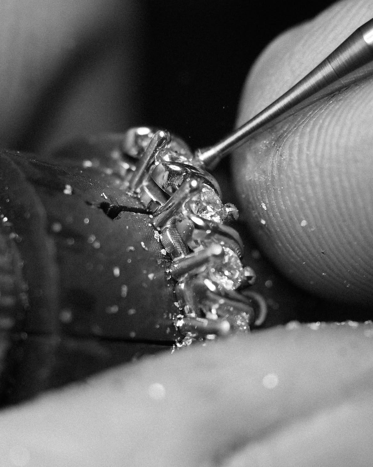 A macro view of milling away the remainder of the bead that closes over the stone after it is set.