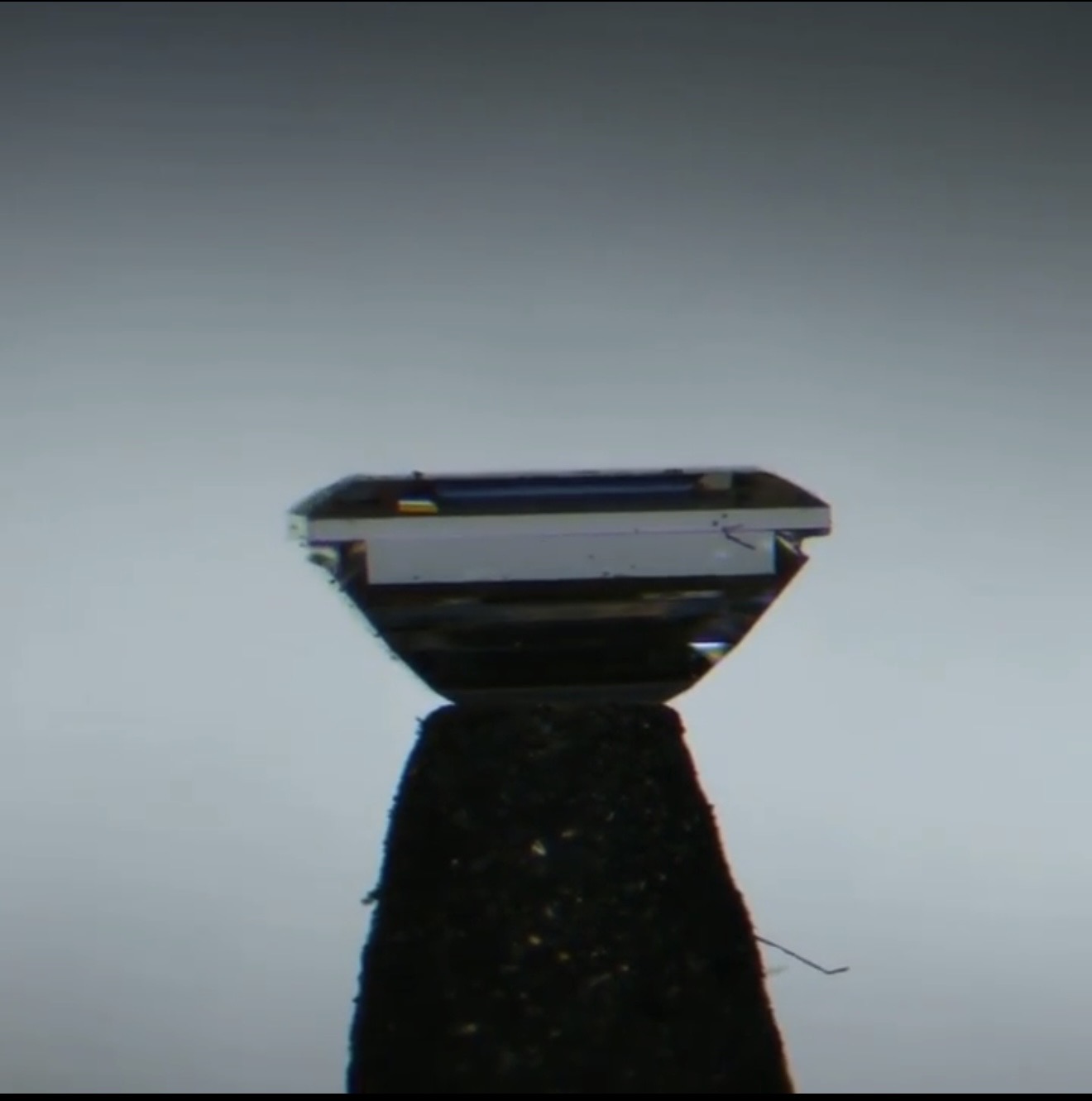 A single stone with the groove cut below the girdle.