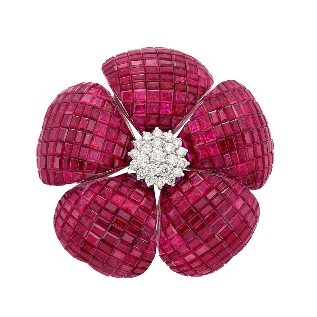 A brooch set with invisibly set rubies, a continuous surface of stones with no visible metal.